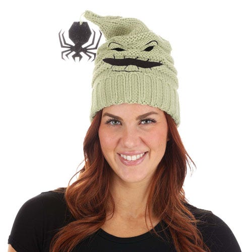 A green knit hat designed to resemble Oogie Boogie from \“The Nightmare Before Christmas,\“ featuring a mischievous face.