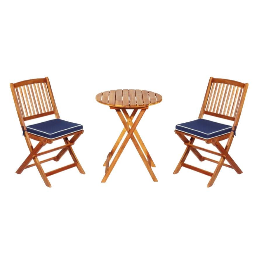 A 3-piece patio dining set featuring a foldable round wooden table and two slatted wooden chairs with navy blue cushioned seats.