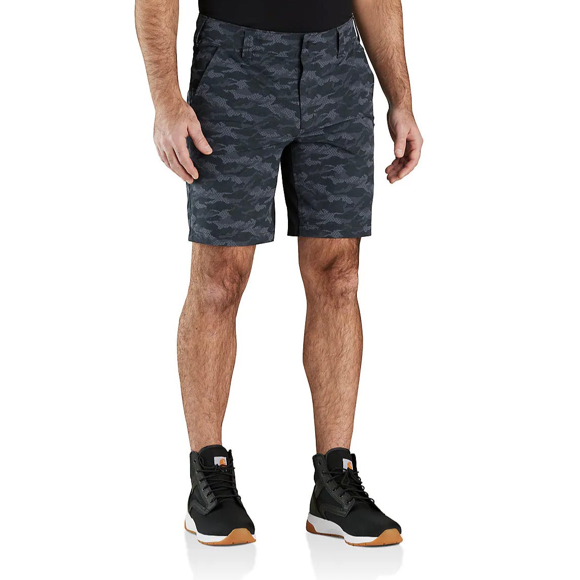 A person is wearing dark camouflage shorts paired with black and white high-top sneakers. The shorts feature a subtle camo pattern, while the sneakers have a brown sole.