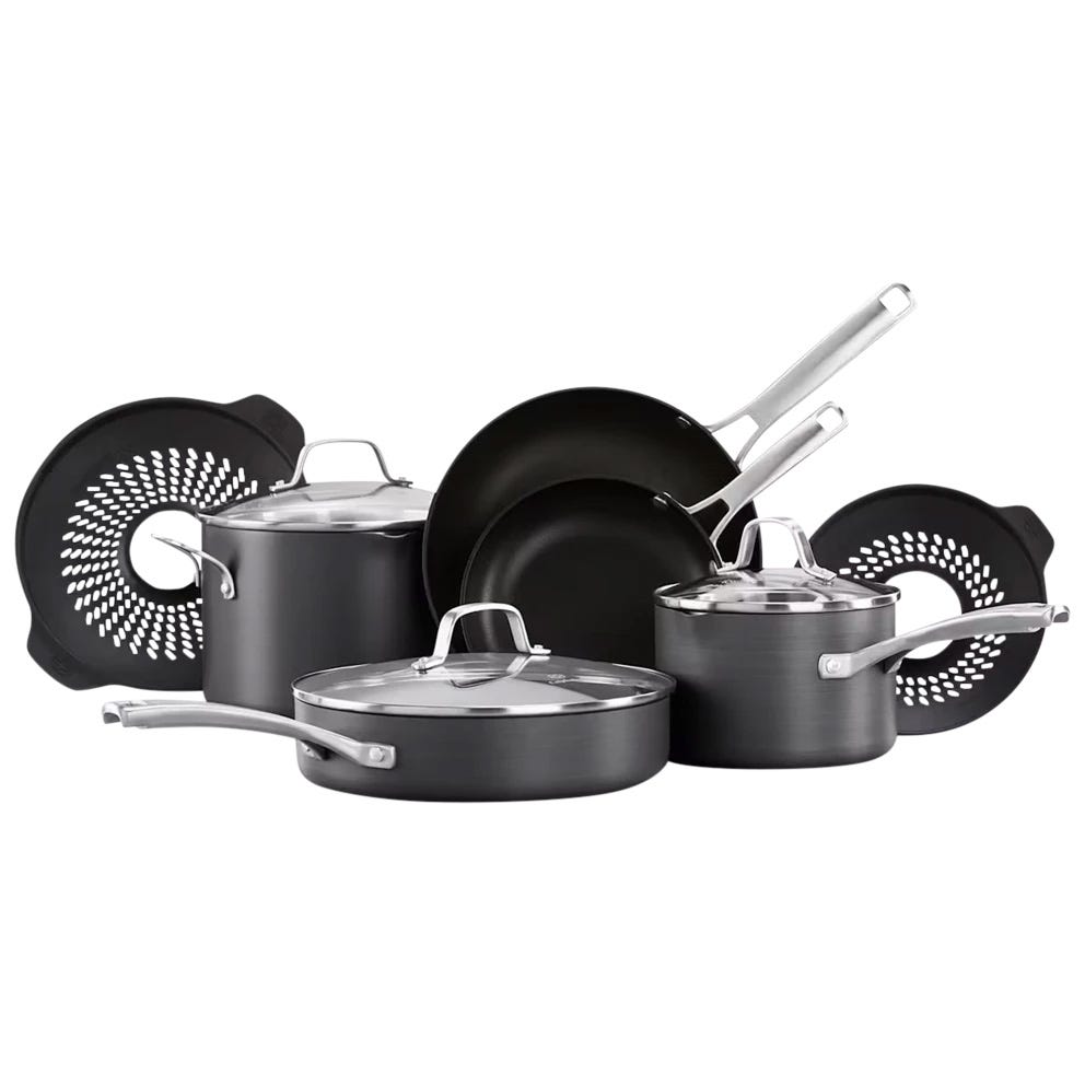 Cookware set with various pots, pans, and lids, featuring two silicone mats. The set has a nonstick surface and silver handles.