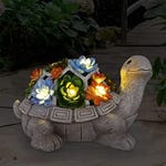 A solar-powered turtle garden statue featuring a shell adorned with flowers and glowing lights.