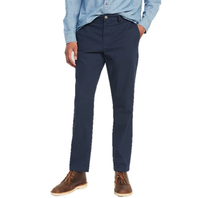 Navy blue chinos paired with brown leather boots and a light blue chambray shirt.