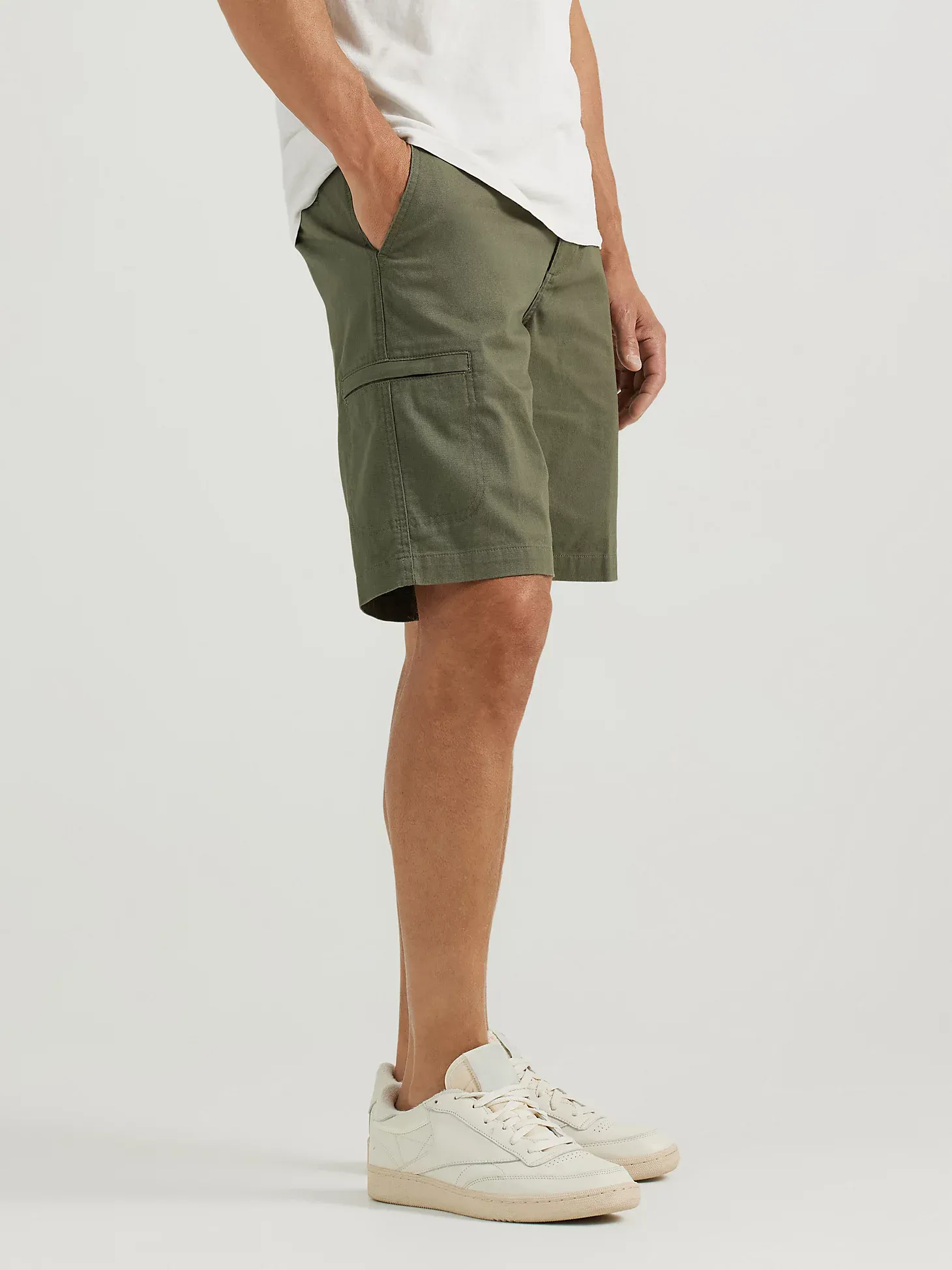 Olive green cargo shorts paired with white sneakers.