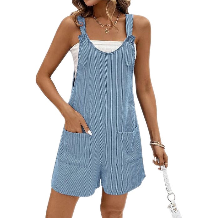 Light blue pinstriped romper with pockets, featuring tie straps and a white top underneath. Accessorized with a necklace, bracelets, and a white handbag.