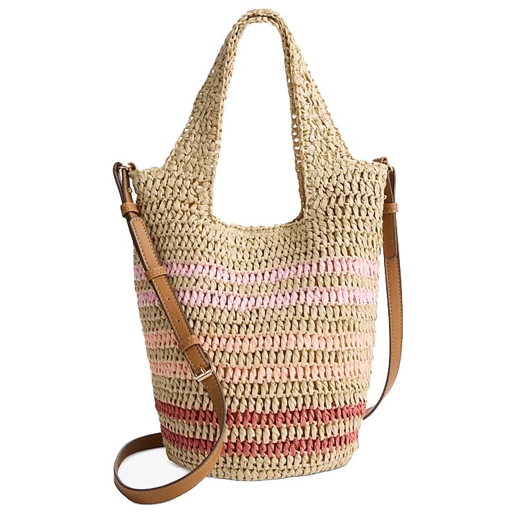 A woven straw tote featuring a soft, packable design with a striped pattern in pink and red hues, complemented by a brown leather shoulder strap and handles.