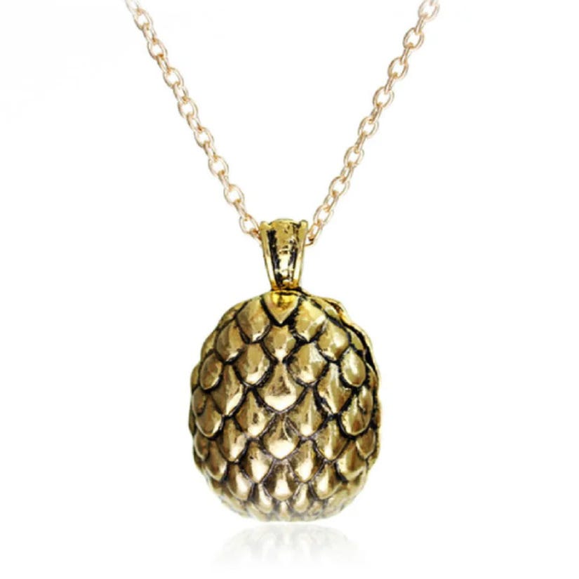 Gold-toned pendant necklace featuring a textured design resembling a dragon egg, suspended on an 18-inch chain.