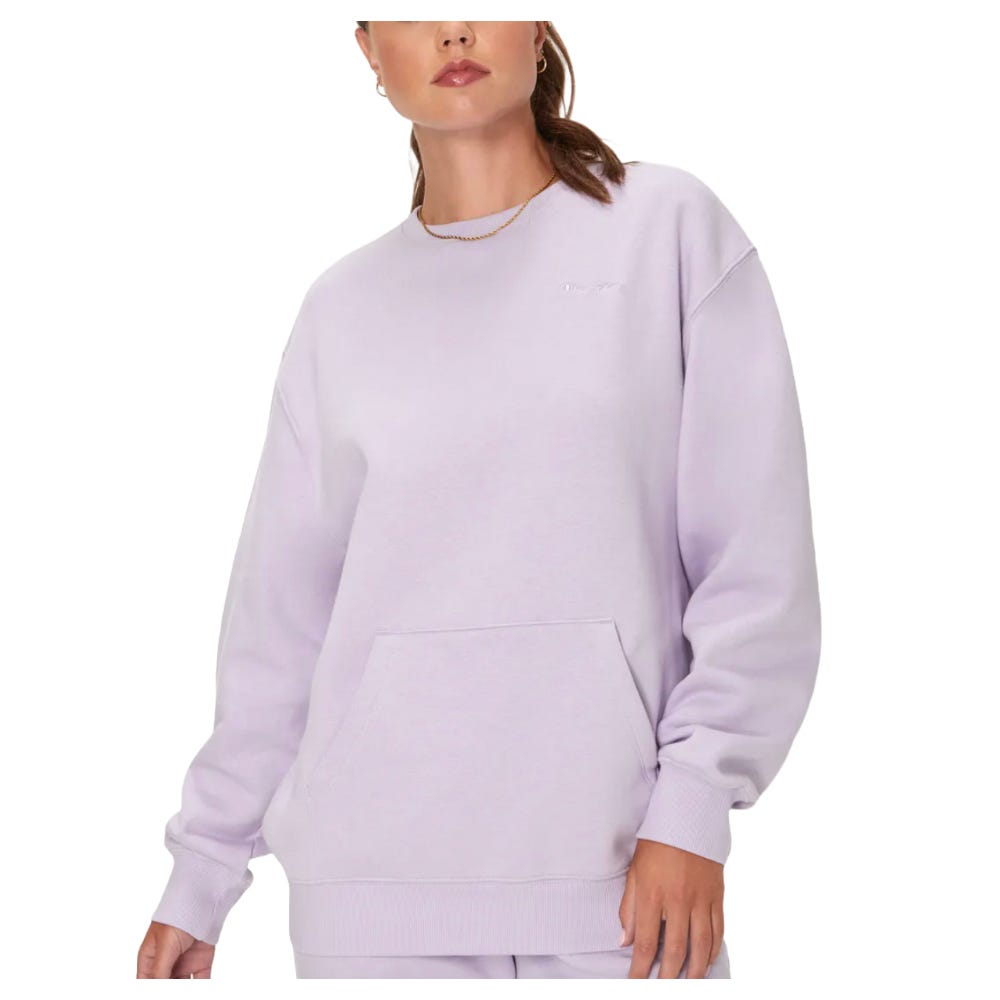 Lilac crewneck Champion sweatshirt with a large front pocket, featuring ribbed cuffs and hem. Simple embroidered logo on the chest, offering a relaxed, comfortable fit.