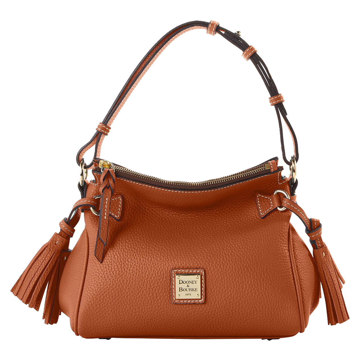A brown Dooney & Bourke pebble leather shoulder bag with a structured design, featuring a zipper closure, tassel accents, and a gold logo plaque on the front. It has an adjustable strap and detailed stitching.
