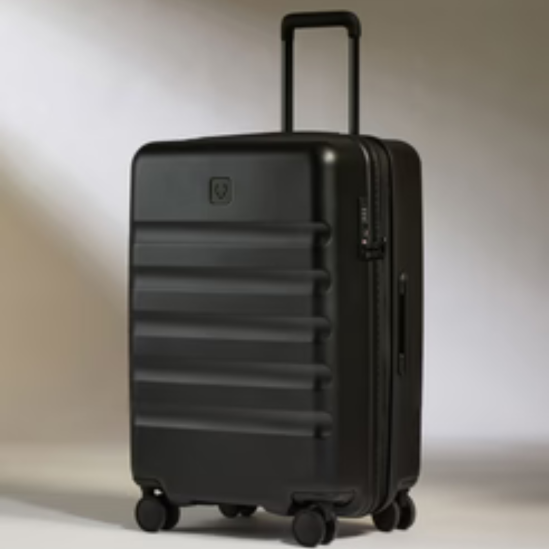 A black, hardshell suitcase with an extendable handle and four wheels.