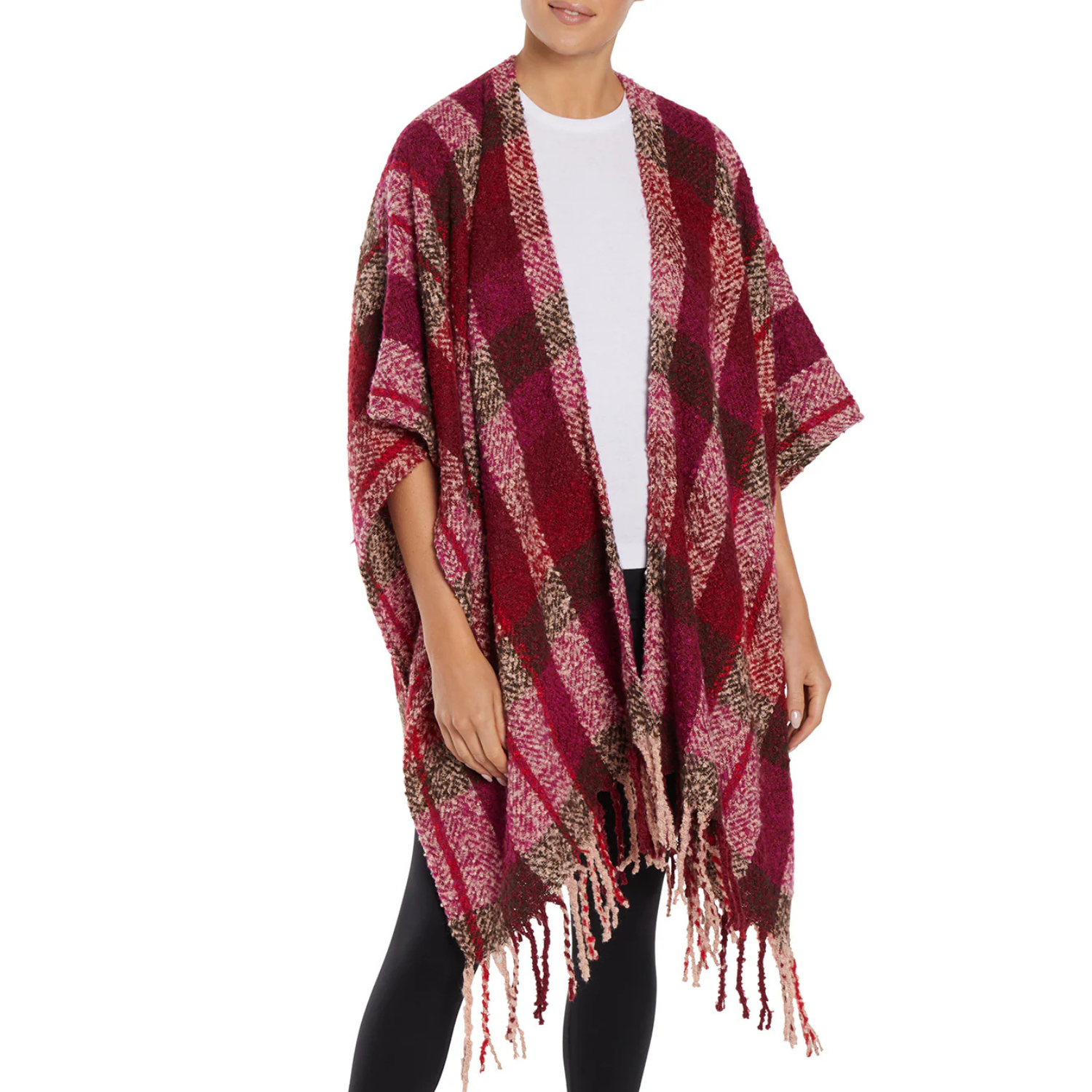 A cozy boucle wrap with a red, pink, and brown plaid pattern and fringe trim, draped over a white shirt and black leggings.