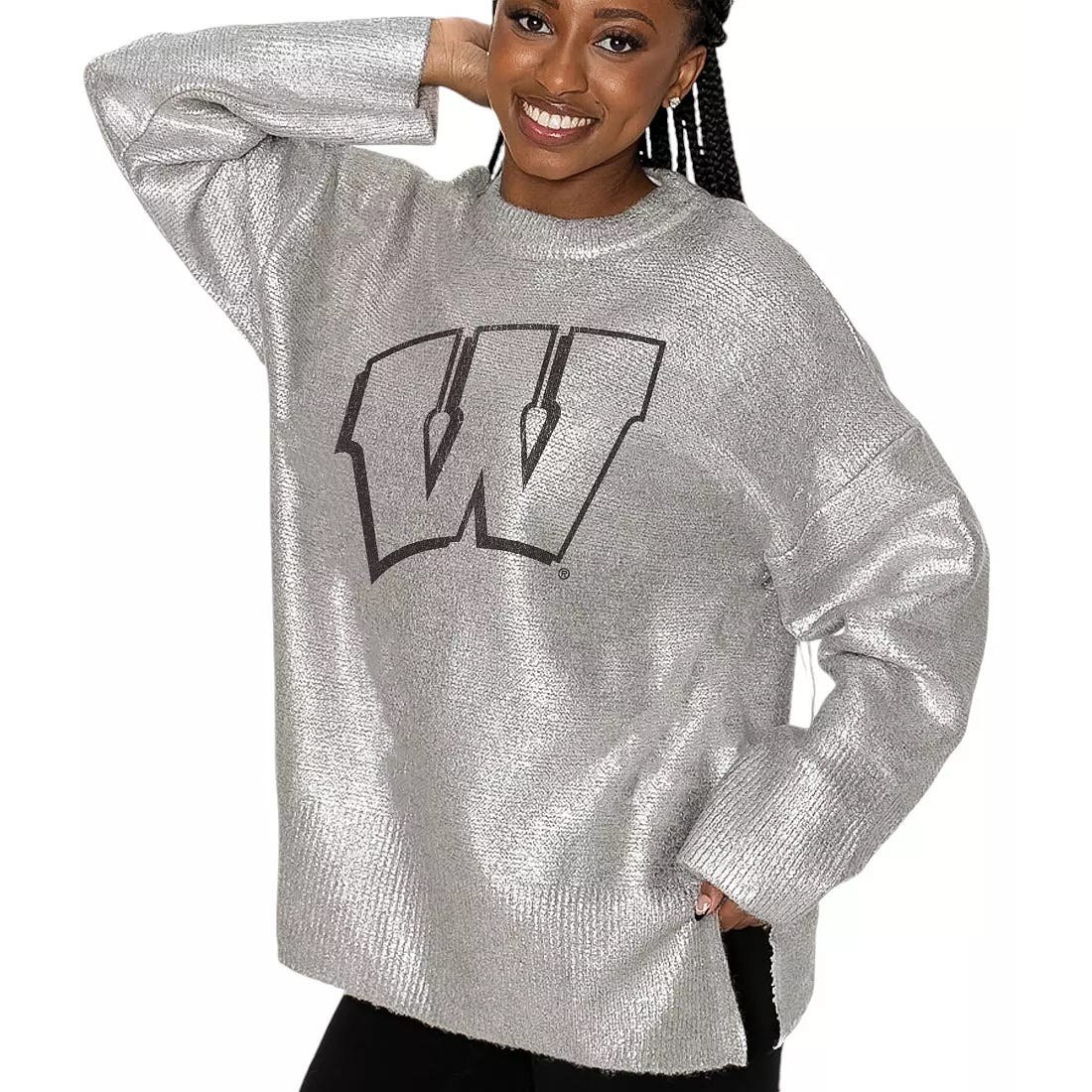 A person wearing a metallic silver oversized sweater featuring a large letter \“W\“ on the front.