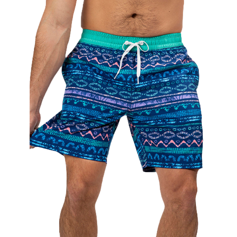 Men's swim trunks with a blue and green patterned design, featuring purple and pink accents. They have an elastic waistband with a white drawstring closure for adjustable fit.