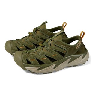 A pair of olive green athletic shoes with prominent soles and lace-up fronts.
