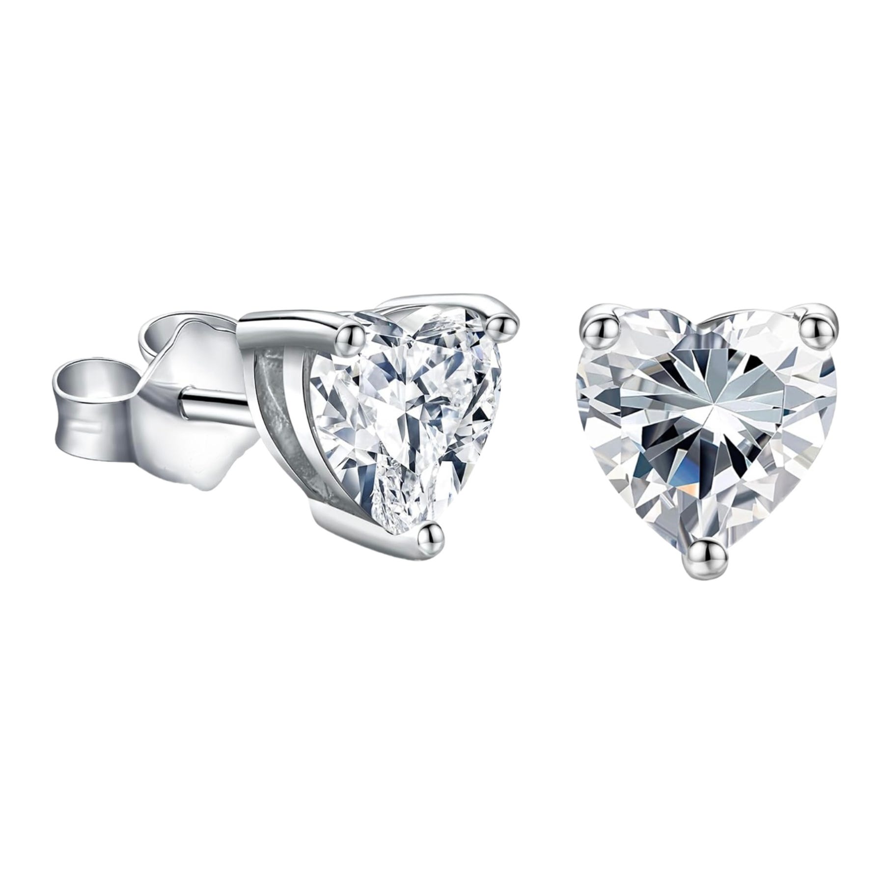 Heart-shaped moissanite studs with a symmetrical, clear gemstone set in a simple prong setting and secured with a butterfly back, all in a silvery metal tone.