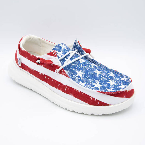 A single shoe with a red and white striped pattern and a blue section with white speckles, resembling the American flag.