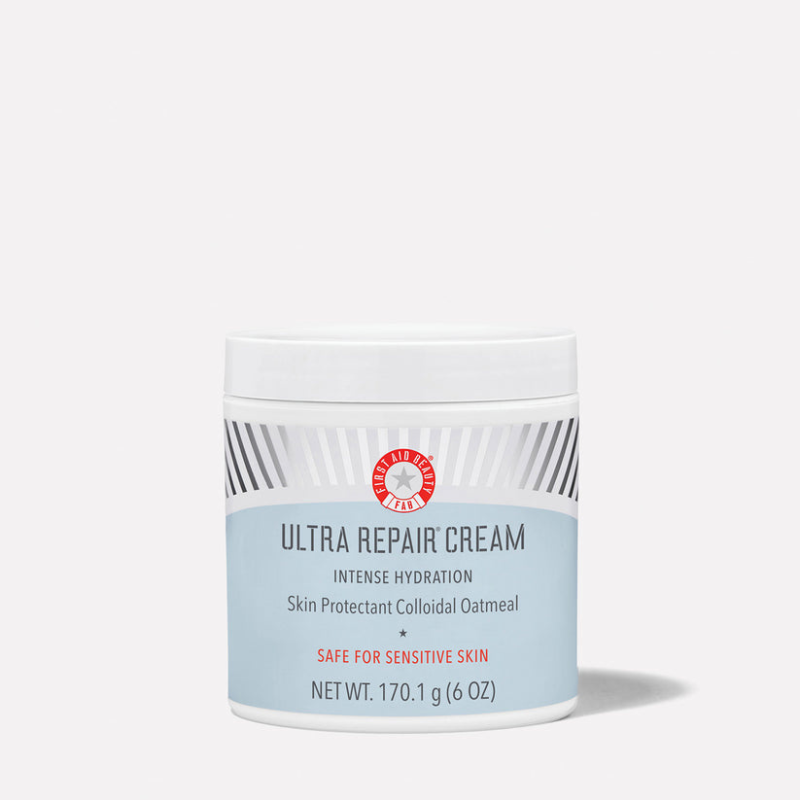 A container of Ultra Repair Cream by First Aid Beauty, offering intense hydration and being safe for sensitive skin, with a net weight of 170.1 g (6 oz).
