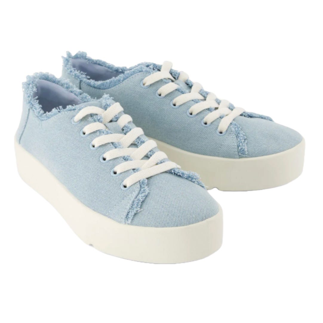 TOMS Verona Sneakers feature light blue denim fabric with frayed edges, white laces, and white platform soles, offering a casual, stylish look.