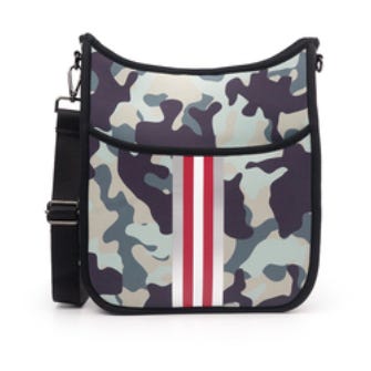 Camouflage messenger bag with a black trim and red and white vertical stripes down the center. It features an adjustable black shoulder strap and a front flap pocket.