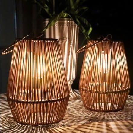 Two illuminated bamboo lanterns casting a warm glow.
