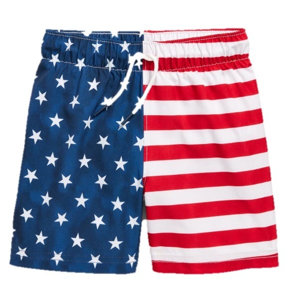 Toddler swim trunks with an American flag design, featuring a blue section with white stars on the left and red and white stripes on the right. They have an elastic waistband and a drawstring.