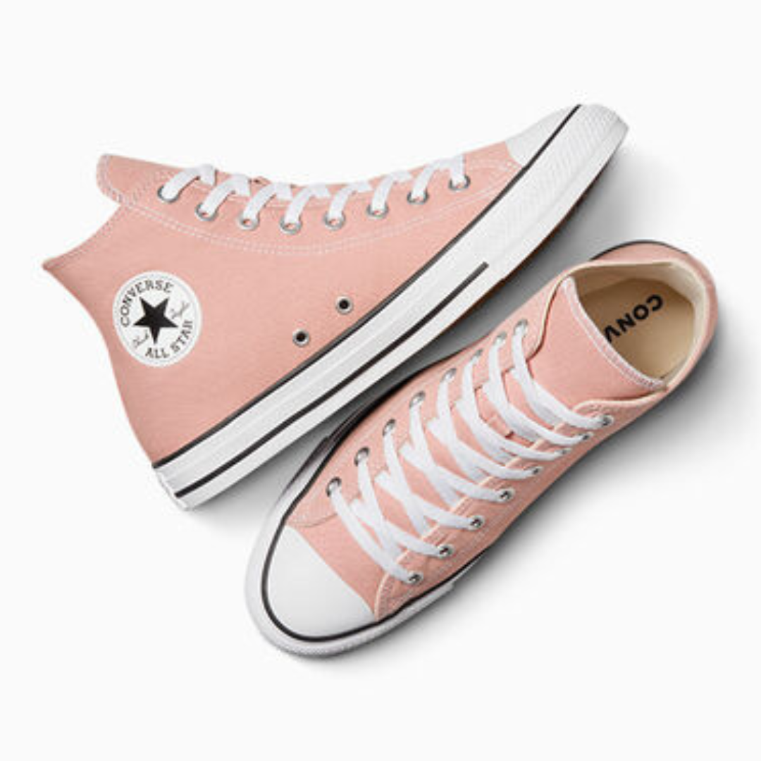 A pair of pink low-top canvas sneakers with white laces and a contrasting white rubber sole.