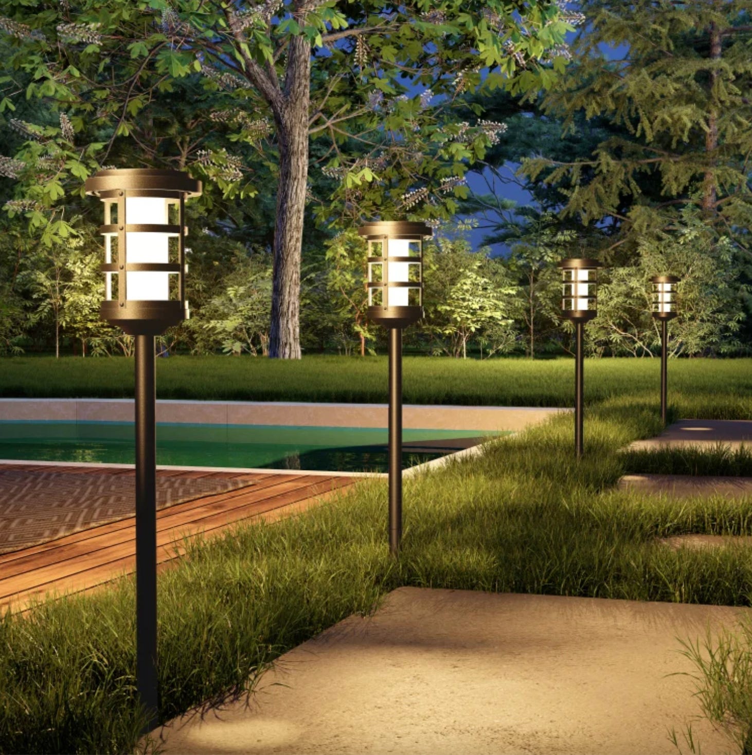 Outdoor pathway lights with a modern design, installed along a path near a pool in a garden setting at dusk.