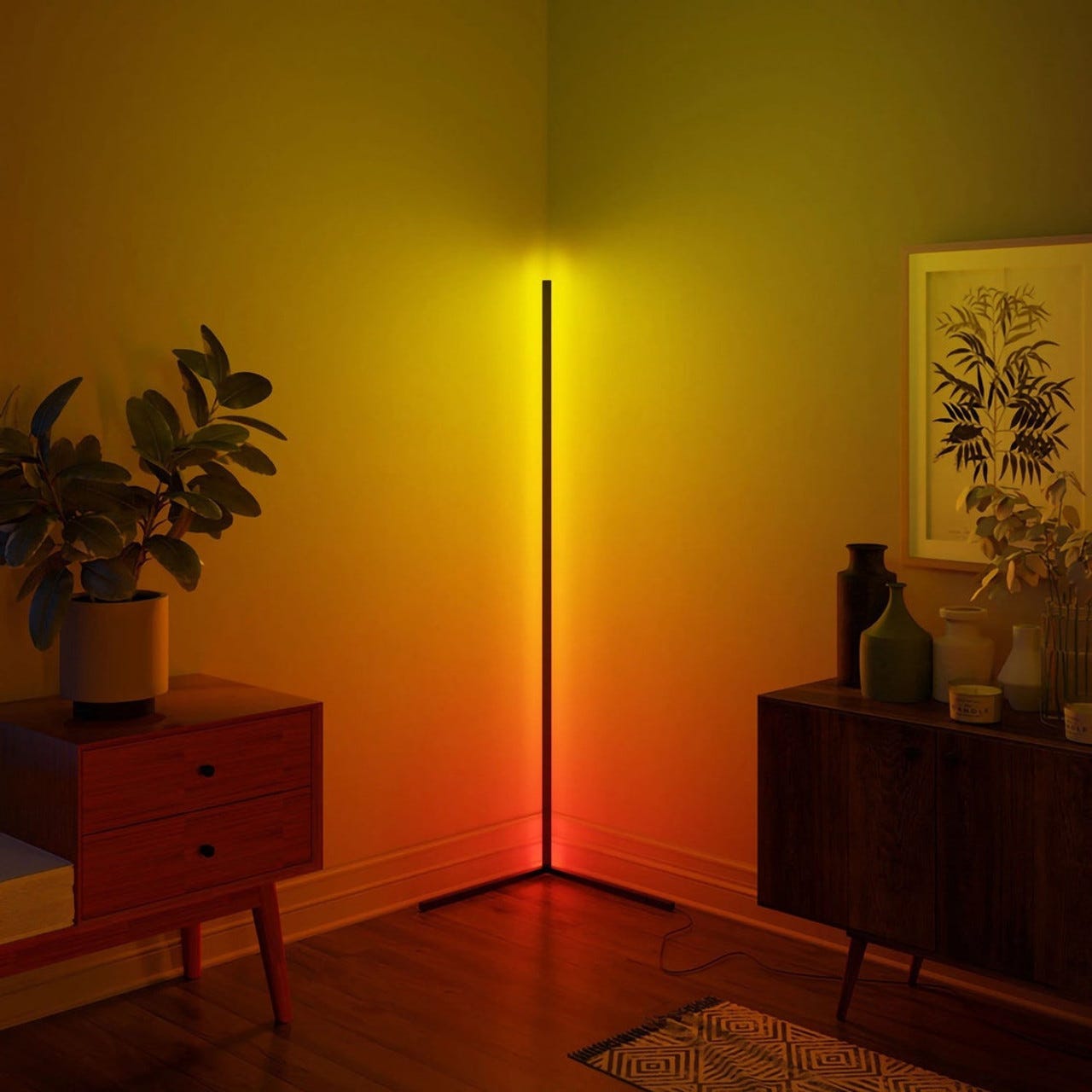 A tall, vertical floor lamp emits a gradient of yellow to red light against a room corner, alongside furniture and decorative items.