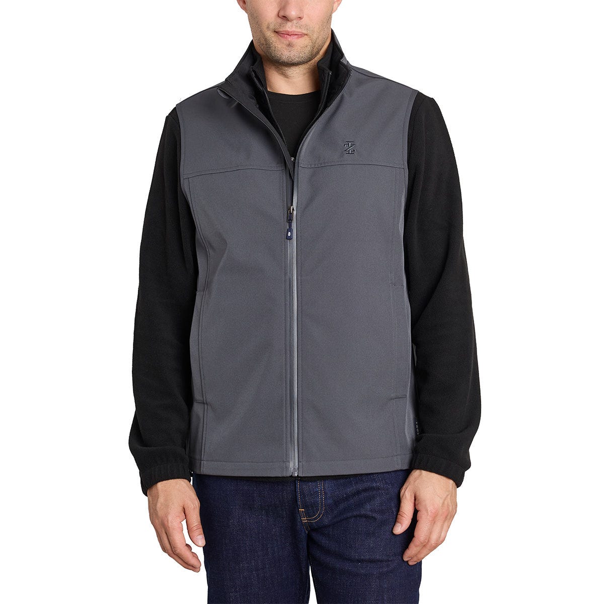 A man is wearing a zip-front, sleeveless softshell vest in shades of gray with black accents around the shoulders and the stand-up collar, complemented by a ribbed hemline.