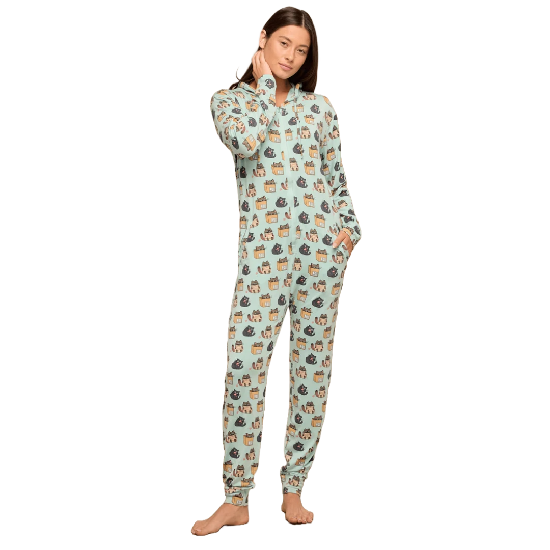 A person is wearing a light blue MeUndies onesie with a playful pattern of cats in boxes. The outfit features a front zipper and relaxed fit, offering comfort and full-body coverage.
