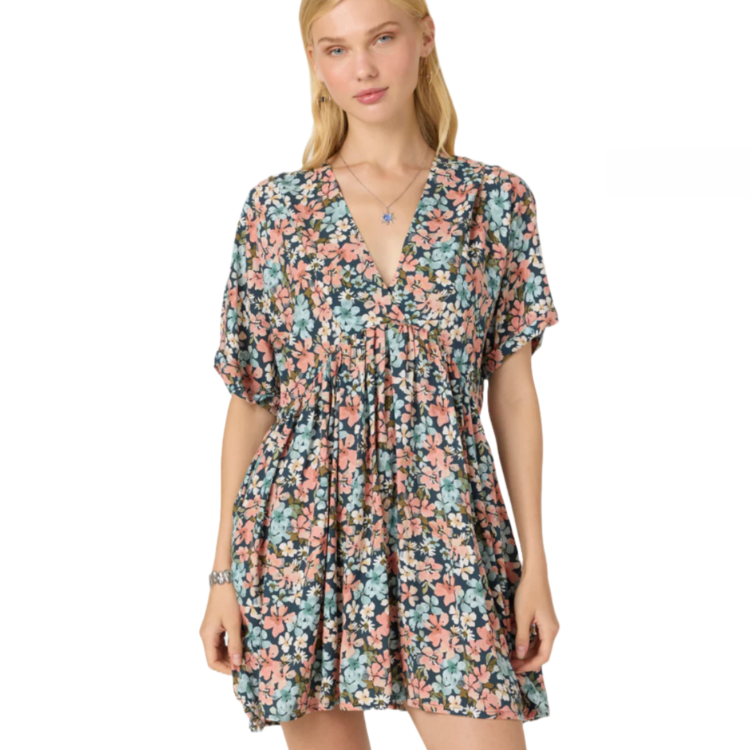 A lightweight, short floral dress from O'Neill featuring a pink and blue pattern, V-neckline, and loose sleeves. The dress has a relaxed, flowy fit.