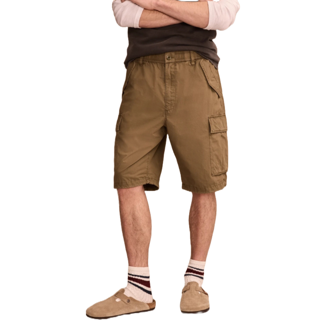 Khaki-colored cargo shorts featuring multiple pockets and an elastic waistband with a button closure. Paired with striped socks and brown slip-on shoes, showcasing a casual, comfortable look.