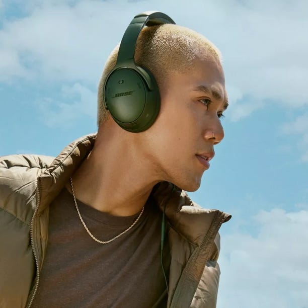The headphones are over-ear with a sleek design and Bose branding on the earcup, suitable for noise cancellation and audio listening. They have a padded headband for comfort.