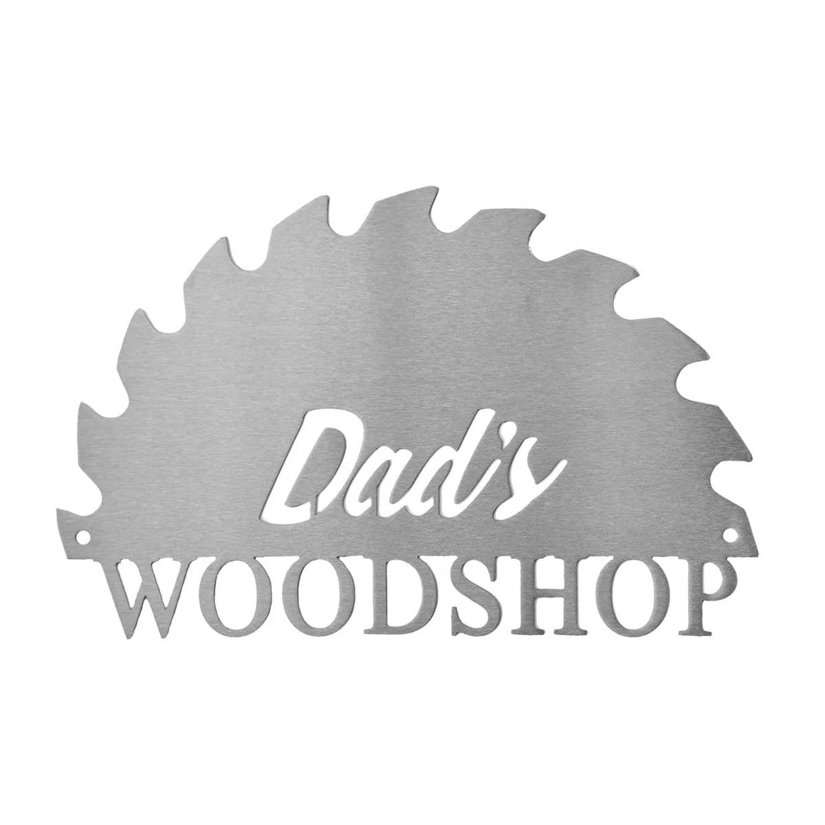 Personalized metal sign featuring the words \“Dad's Woodshop\“ cut out in the shape of a circular saw blade.