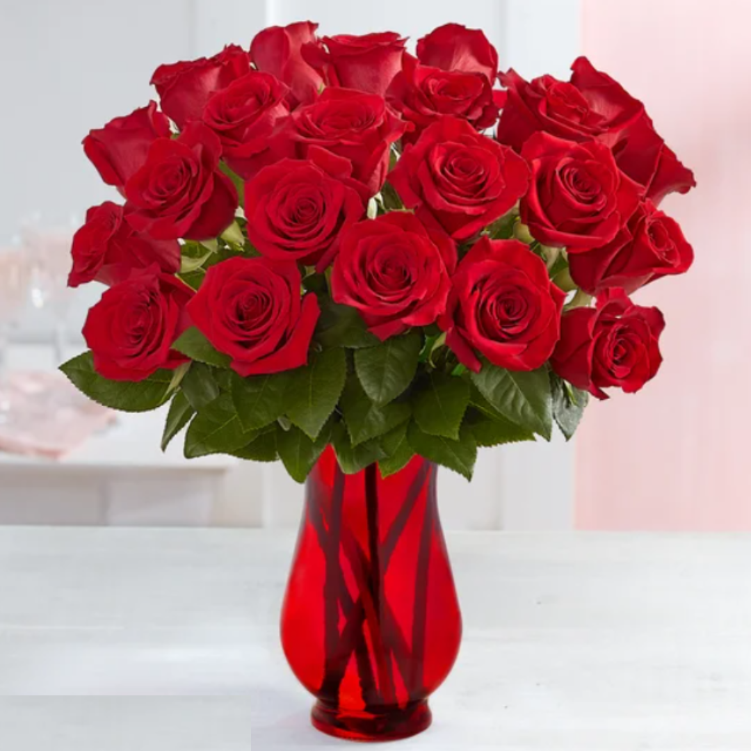 A bouquet of red roses in a red vase.