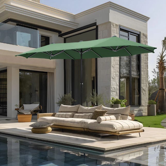 Large green patio umbrella, beige outdoor sofa set on a poolside deck.