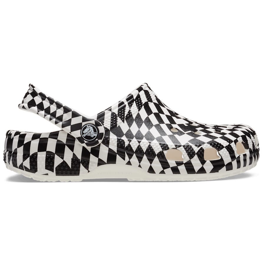 A black and white checkered Crocs clog with adjustable heel strap and ventilation ports.