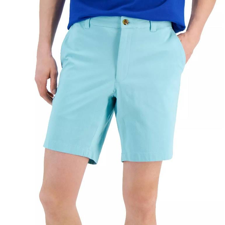 Light blue shorts with a button closure and pockets worn by a person with a blue top.