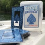 A deck of Hoyle waterproof playing cards with a blue swirl design, displayed outside their clear storage case.