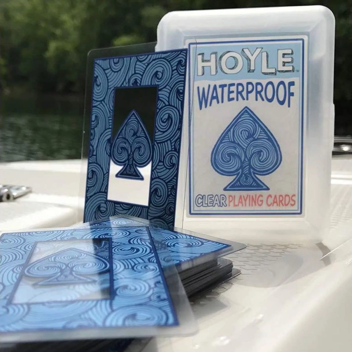 A deck of Hoyle waterproof playing cards with a blue swirl design, displayed outside their clear storage case.