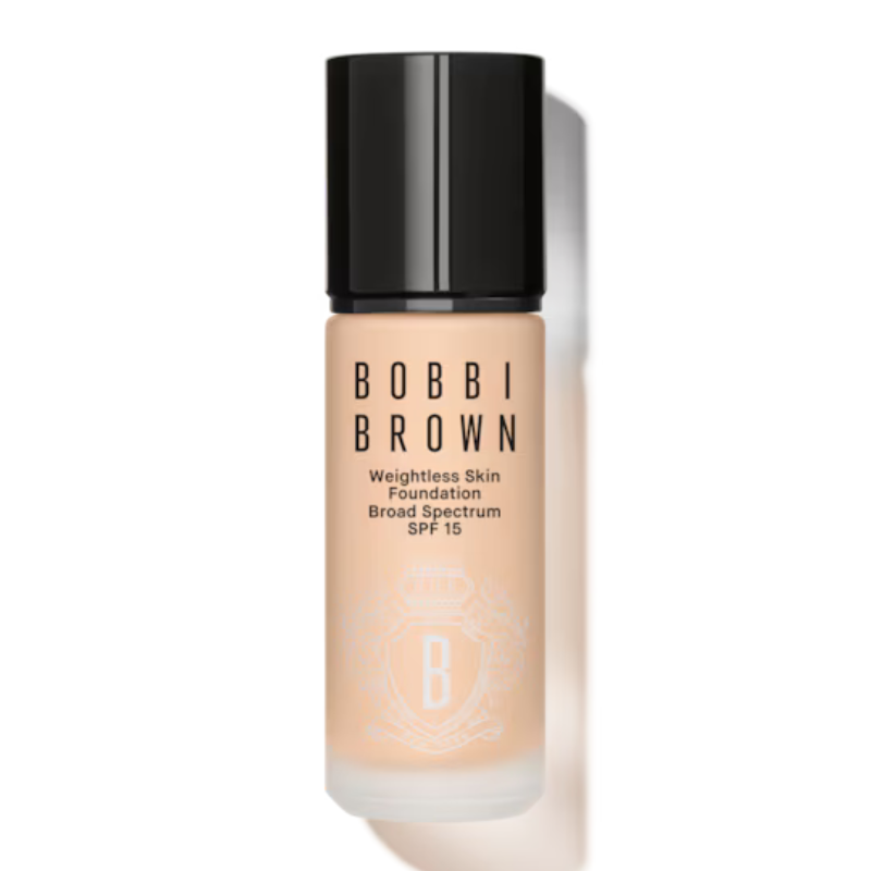 Bobbi Brown Mini Weightless Skin Foundation is a lightweight foundation with SPF 15, designed for even coverage. It comes in a small bottle with a sleek black cap.