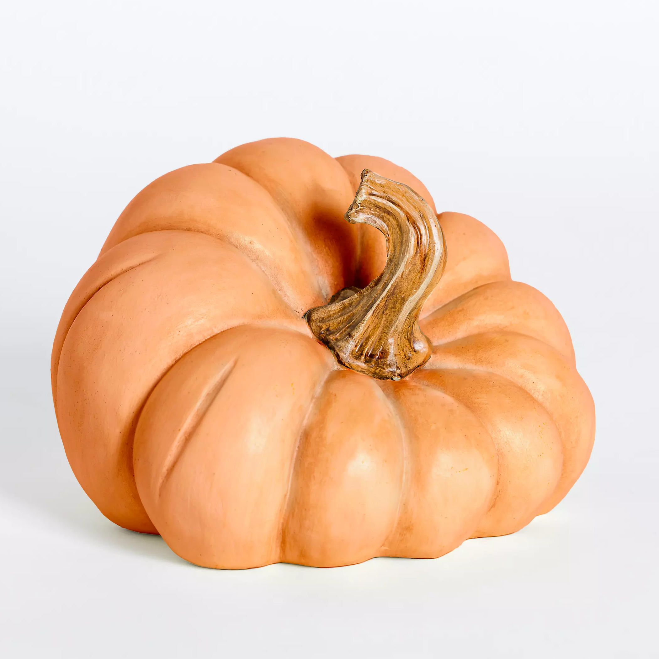 A ceramic pumpkin decoration with a realistic stem.