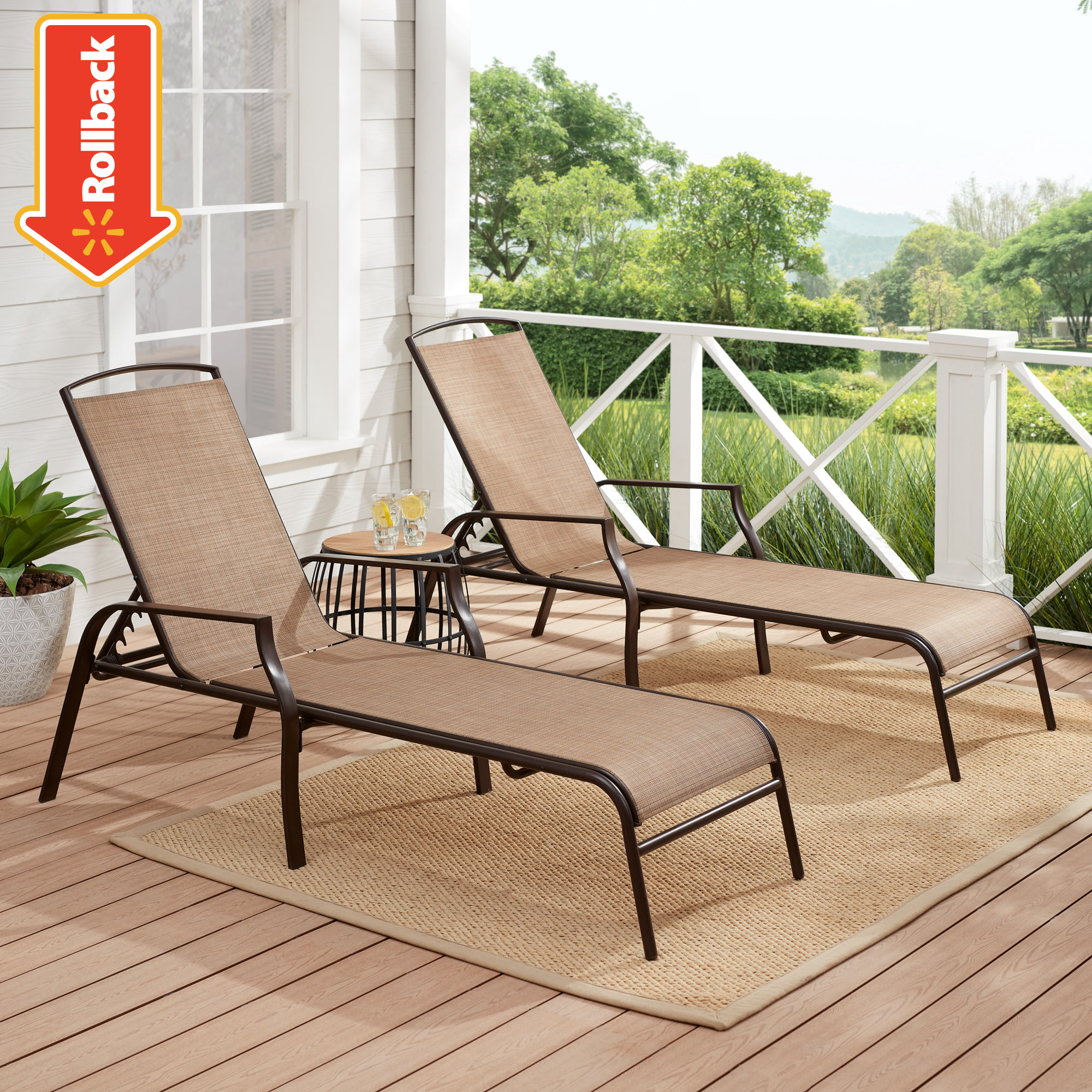 Two adjustable outdoor loungers with beige sling fabric on a porch, one upright and one reclined, with a small table between them.