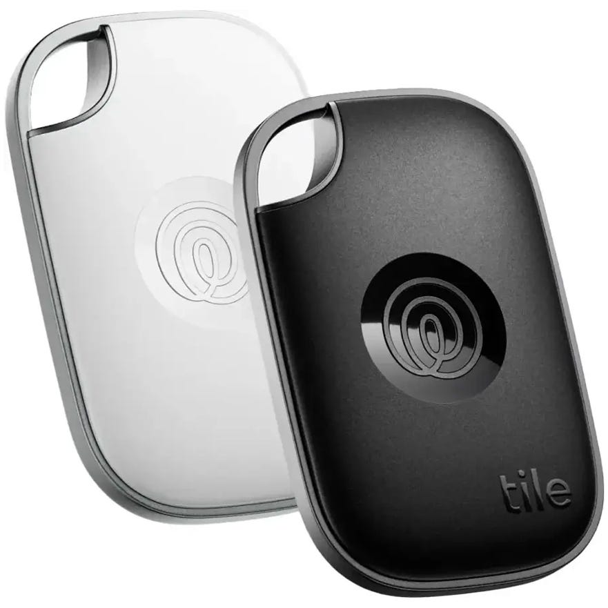 Two Tile Bluetooth trackers, one in black and one in white, designed for locating items such as keys or bags.