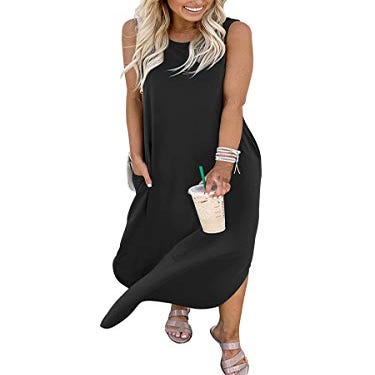A woman is wearing a sleeveless, black maxi dress featuring high-low hemline and side pockets, paired with strapped sandals.