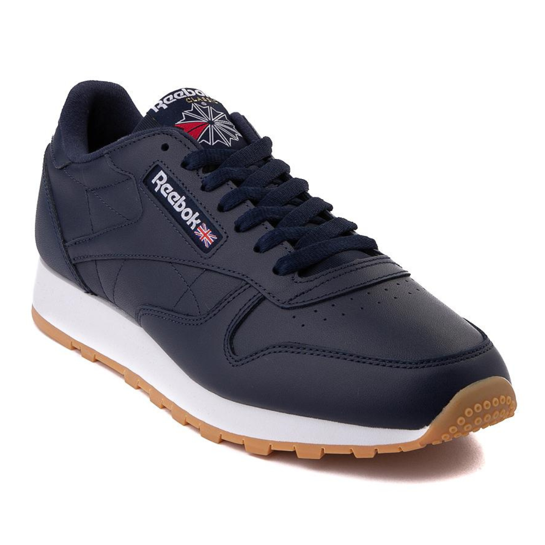 Dark blue Reebok sneaker with white midsole and gum outsole.