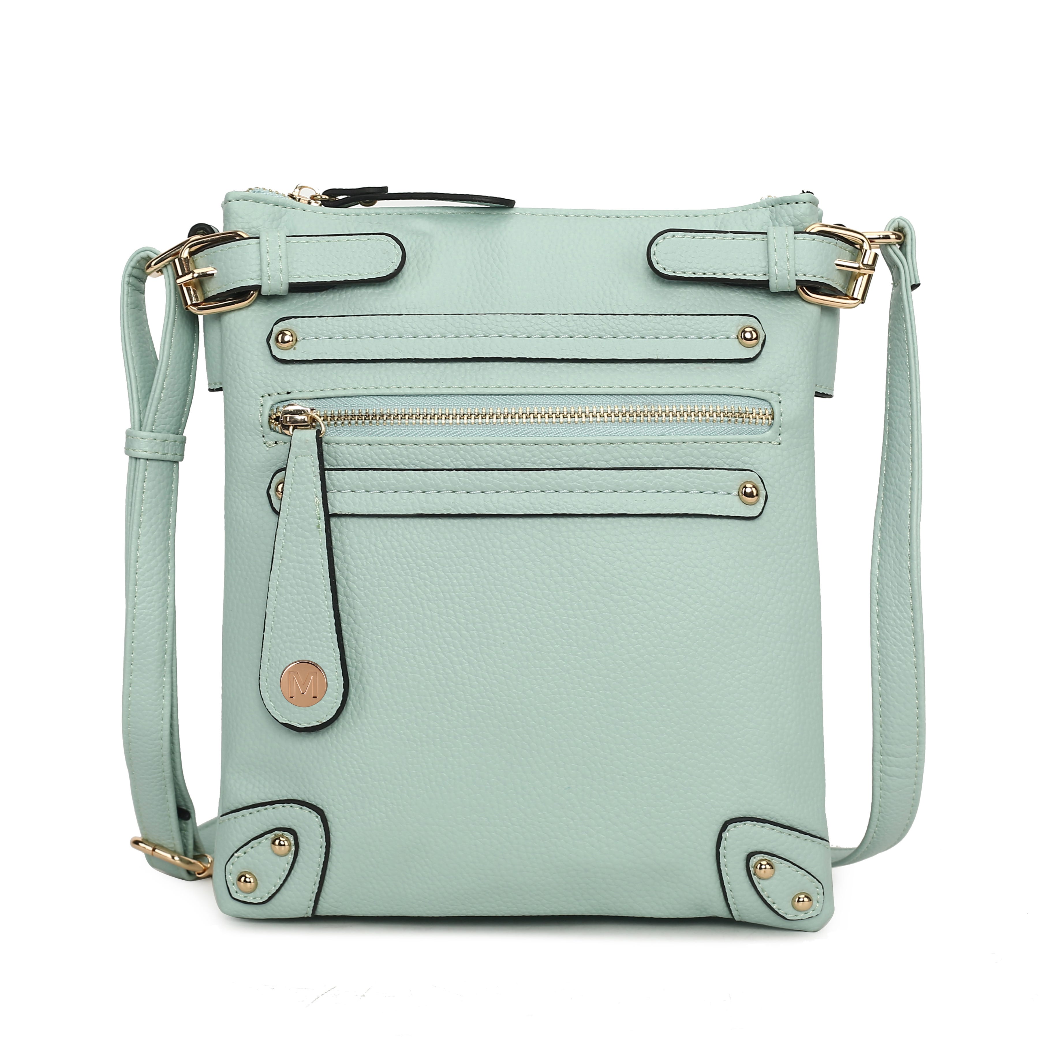 A mint green crossbody bag with gold-toned hardware, featuring multiple zippered pockets and an adjustable strap.