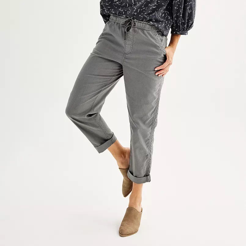 Gray jogger pants and beige slip-on shoes.