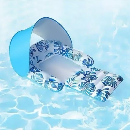 Inflatable pool float with a palm leaf design and an attached canopy for shade, floating on water.