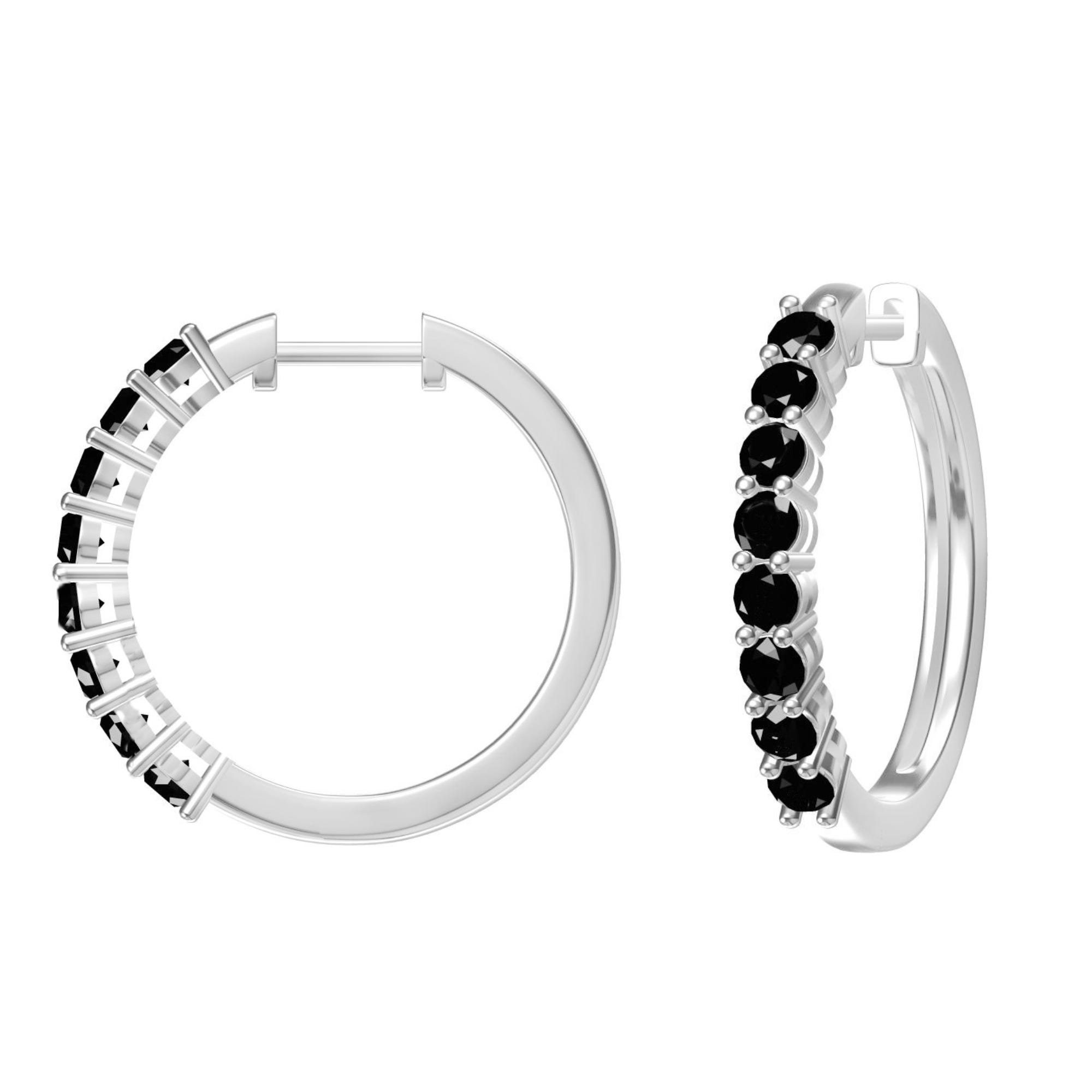 A pair of silver hoop earrings with black gemstone embellishments.