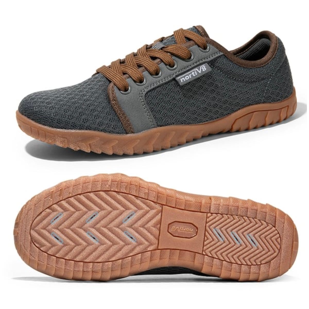 A pair of dark gray sneakers with brown laces and a brown sole, displayed from the side and bottom view.
